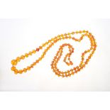 Old amber necklace with a string of graduated faceted amber beads, 129cm long.