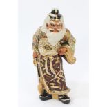 Early 20th century Japanese Satsuma earthenware figure of a warrior holding a sword,