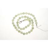 Chinese green hardstone bead necklace with a string of spherical beads approximately 8mm diameter,