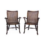 Unusual pair of Arts & Crafts beech bergère open-arm chairs retailed by Merryweather, Holloway,