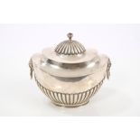 Edwardian silver tea caddy of oval half-fluted form, with twin lion mask ring handles,