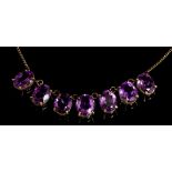Amethyst necklace with seven oval mixed amethysts in claw setting, on trace chain,