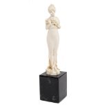 Fine 1920s German carved ivory figure of an elegant standing girl holding a garland of flowers,