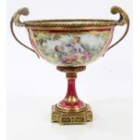 Early 20th century Continental gilt metal and porcelain urn with painted Romantic reserves on red