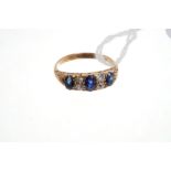 Edwardian sapphire and diamond ring with three oval mixed cut blue sapphires and four old cut
