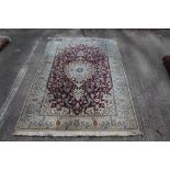 Eastern rug, having central petalled medallion issuing scrolling vine-work on claret ground,