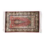 Fine quality Kalim silk rug with peacock, exotic birds, flora and fauna, on red and green ground,