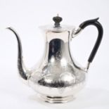 Early 20th century silver coffee pot of baluster form, with engraved floral and foliate decoration,