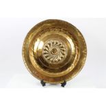 17th century Nuremberg brass alms dish with central raised boss and text bands,