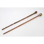 Two 19th century novelty walking sticks - both with carved and painted human head knops