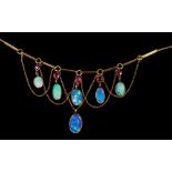 Edwardian opal and ruby fringe necklace with six graduated oval cabochon opals suspended from five