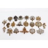 Collection of British Military cap badges - including the Cheshire Regiment and the Essex Regiment
