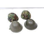 Two military tin helmets - one stamped - 1958,