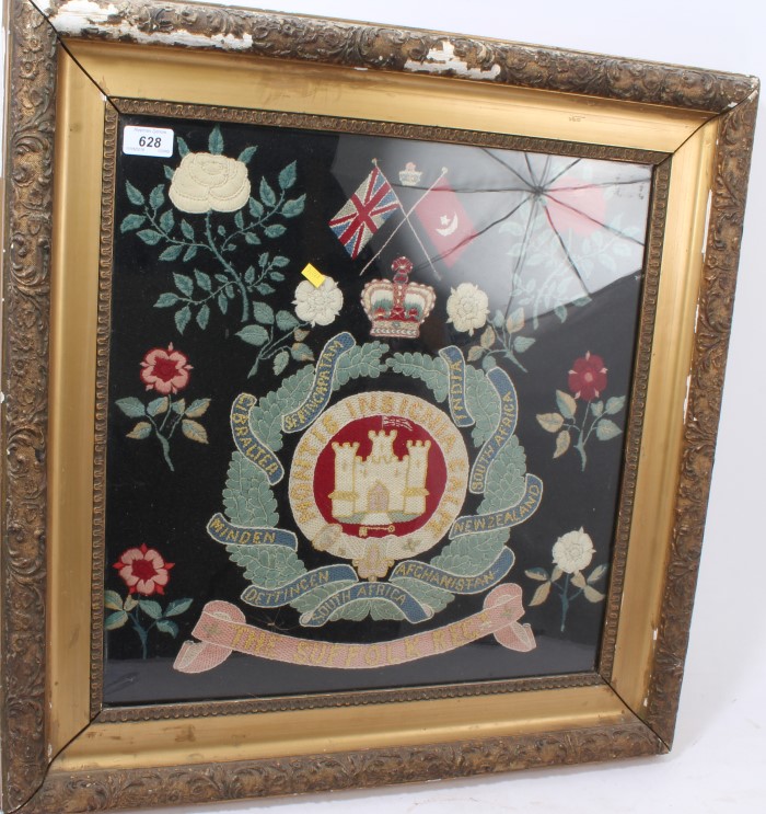 First World War era Suffolk Regiment embroidered panel with regimental badge amongst flowers,