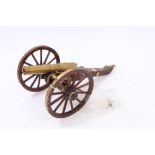 Decorative scale model of a Napoleonic-style cannon with wooden carriage and brass mounts, 36.