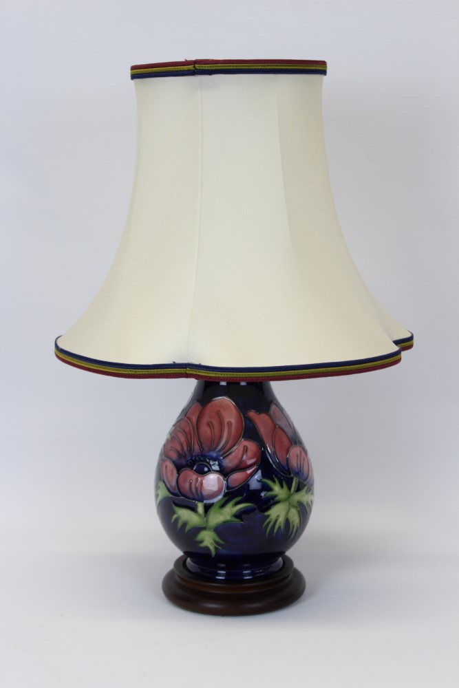 Moorcroft pottery table lamp decorated in the Anemone pattern on blue ground,