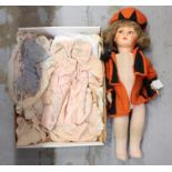 Doll - 1930s fabric doll with painted composite face, wearing orange and black felt hat and coat,
