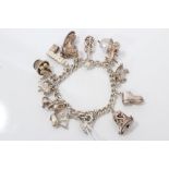 Silver charm bracelet with quantity of silver and white metal novelty charms
