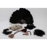 A curly black ostrich feather fan, some large loose ostrich feathers,