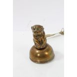 Early 20th century novelty brass tape measure with dog surmount,