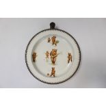 Old warming dish decorated with teddy bears playing cricket,