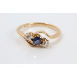 1920s gold (18ct) sapphire and diamond three stone crossover ring.