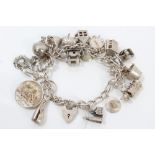 Silver charm bracelet with quantity of silver and white metal charms