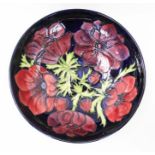 Moorcroft pottery bowl decorated in the Poppy pattern on midnight blue ground, impressed marks,