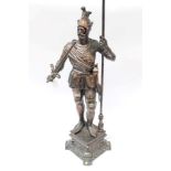 Coppered spelter model of a standing medieval knight in armour, holding a sword and halberd,