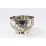 Edwardian silver bowl of circular fluted form, with raised floral decoration,