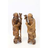 Pair Oriental carved hardwood figures of Shou Lao holding a staff and peach