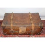 Large Edwardian heavy duty leather steamer trunk with wooden sliders underneath,