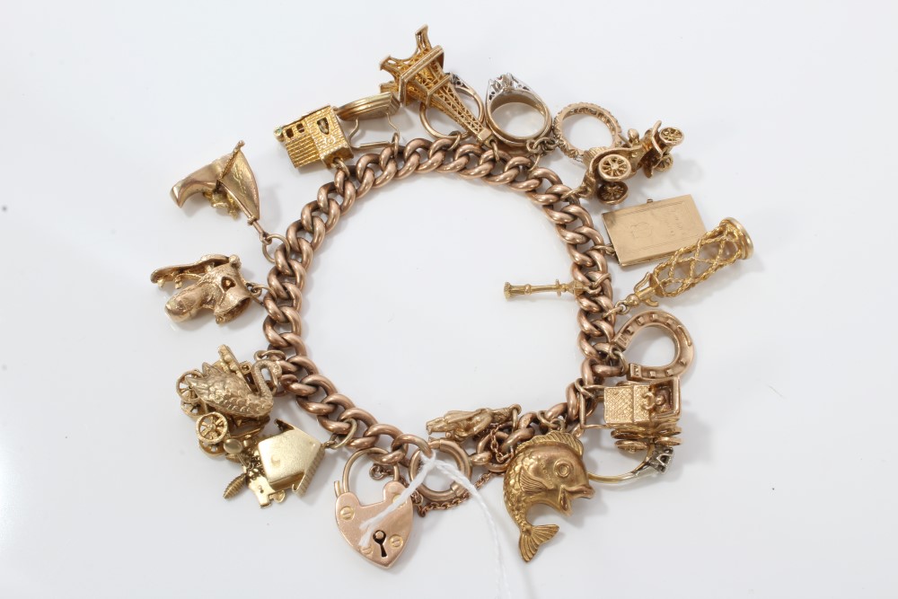 Gold (9ct) charm bracelet with quantity of gold (9ct) and yellow metal novelty charms