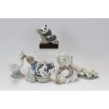 Three Lladro porcelain figures - Eskimo with polar bear cub, girl washing a dog,