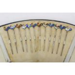 Set of twelve silver cocktail sticks (stamped Sterling), with enamelled cockerel terminals,