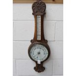 Aneroid banjo barometer with 8 inch dial (glass cracked) and separate thermometer in a carved oak