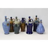 Collection of seven Royal Doulton stoneware flagons - including one with leaf and berry decoration