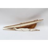 Pond yacht with wooden hull, mast and sails,