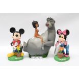 Twelve Disney and other similar garden ornaments