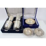 Four Indian silver / white metal beakers in fitted velvet box,