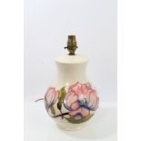 Moorcroft pottery table lamp decorated in the Magnolia pattern on cream ground,