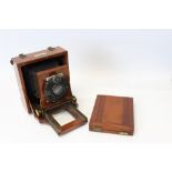 A Lancaster mahogany and brass plate camera fitted with a Lompro Doppel Anastigmat lens of 135mm