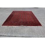 Pakistan Tekke-style rug with nine rows of twenty quartered guls on blood-red ground and multiple