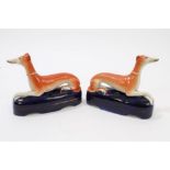 Pair Victorian Staffordshire seated greyhound pen-holders,