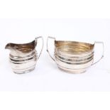 Late 18th / early 19th century Irish provincial silver sugar and cream jug of bellied form,