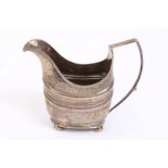 George III Irish silver cream jug of helmet form, with bright cut and banded decoration,