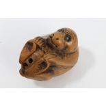 Japanese carved boxwood netsuke modelled as a monkey, with turquoise inset eyes, signed - Gyakusho,