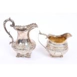 Late William IV silver cream jug of baluster form, with raised scroll and floral decoration,