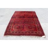 Tekke-style carpet - having two rows of five quartered medallions in geometric borders,