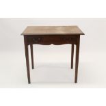 George III mahogany side table with single frieze drawer and shaped apron on square tapered legs,